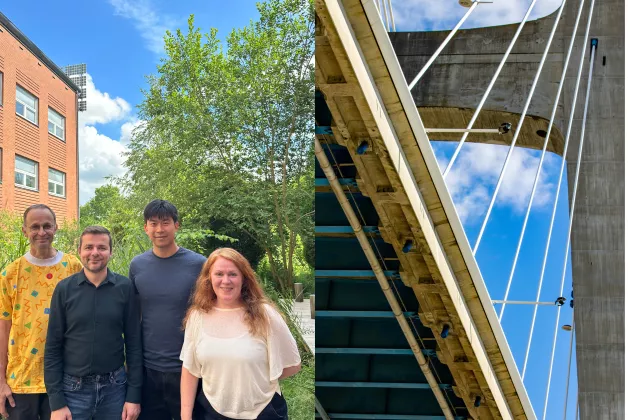 Research team standing together next to image of a bridge